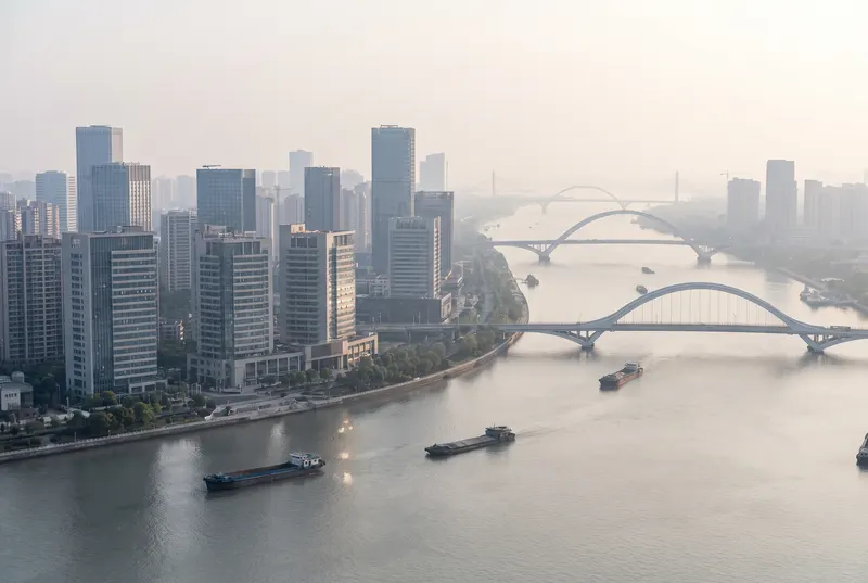 Ningbo city skyline and bridges over the river in morning haze